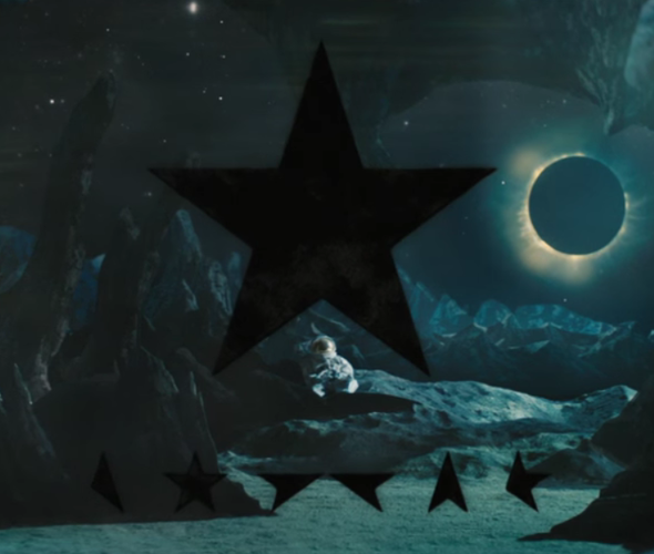 A black star and star glyphs are featured with the dead astronaut and eclipsed star.